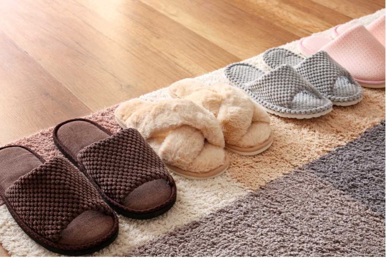 a variety of comfy slippers sitting on a rug