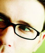 Upclose image of a man's face wearing glasses