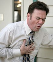 A man with his hand over his heart and a painful facial expression.