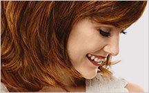 smiling woman with red wig