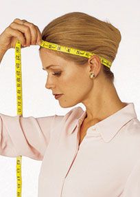 woman measuring around head