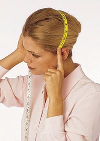 woman measuring head ear to ear